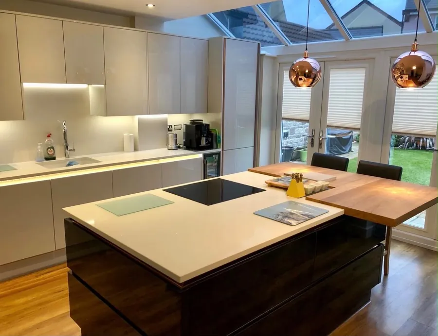 Kitchen with island, copper pendant lighting and glazed roof